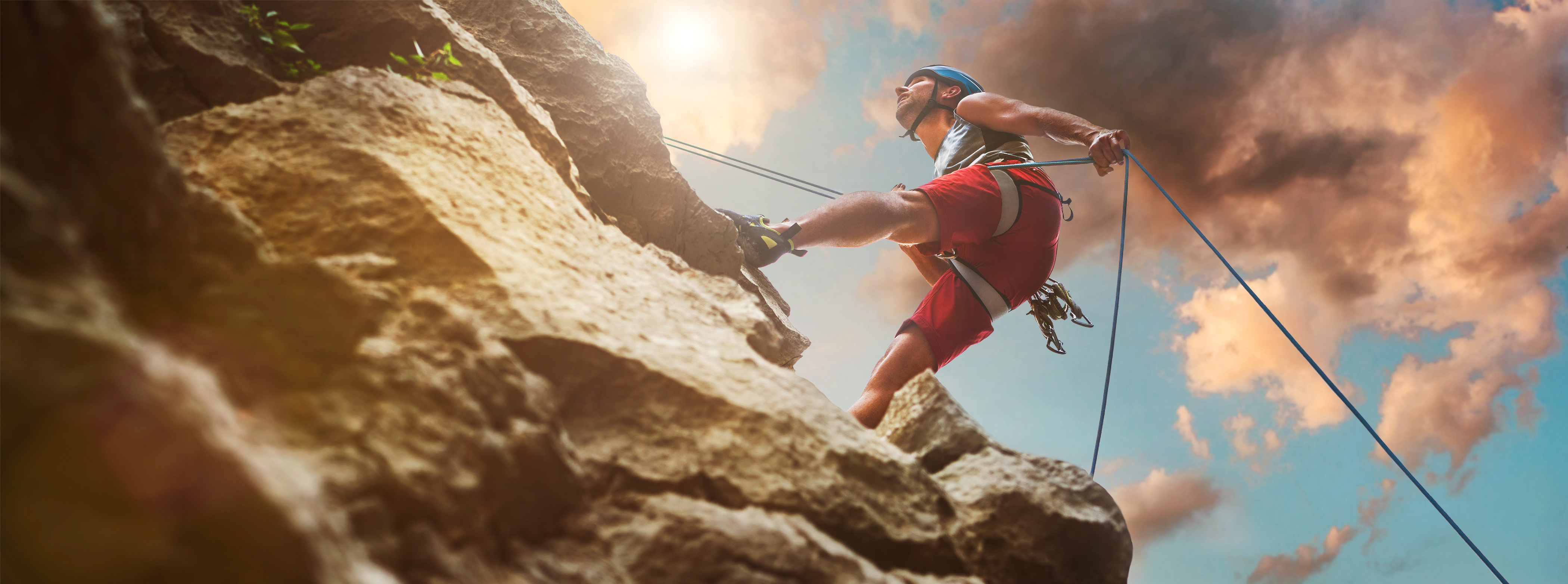 Rock climber scaling a challenging cliff, embodying the spirit of adventures and exploration